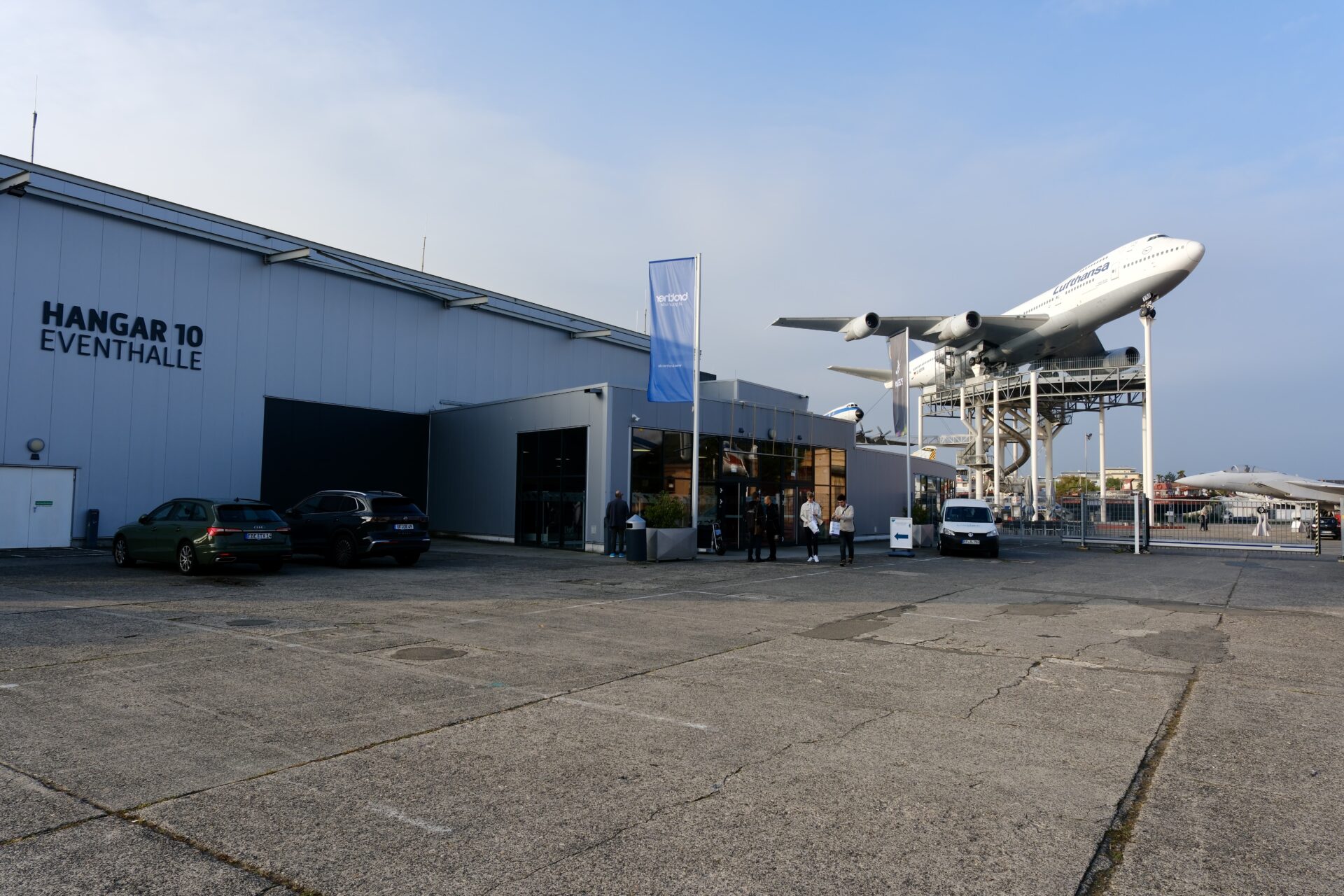 Außenansicht Hangar 10 Eventhalle am Technikmuseum Speyer mit Jumbo-Jet auf dem Dach und BEYOND BARCODE-Fahne